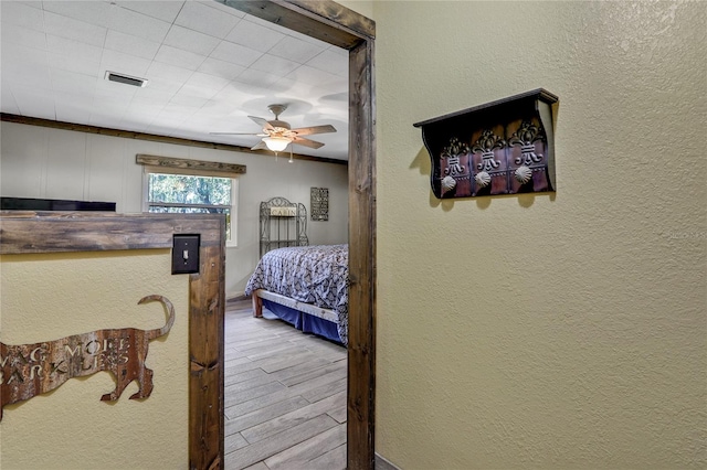 bedroom with ceiling fan and light wood-type flooring