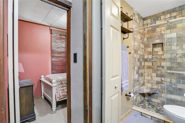 bathroom with tile patterned flooring, vanity, an enclosed shower, and toilet