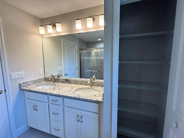 bathroom with vanity and a shower with shower door