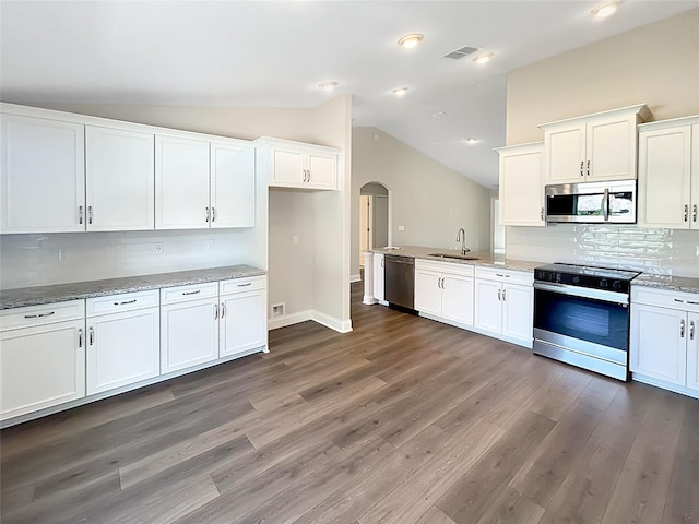 kitchen with white cabinetry, sink, lofted ceiling, and stainless steel appliances