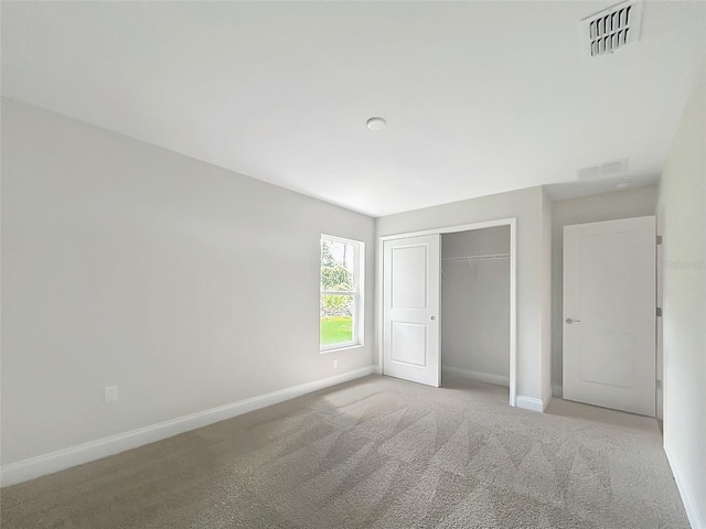 unfurnished bedroom featuring carpet floors and a closet