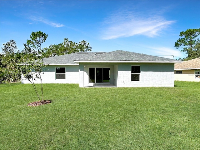 rear view of property featuring a yard