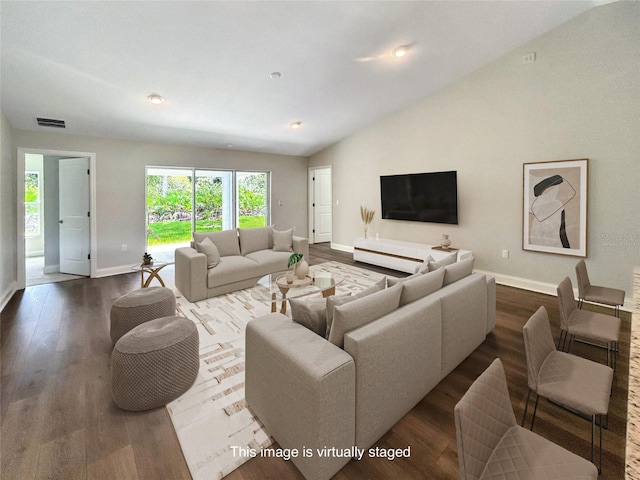 living room with hardwood / wood-style floors and lofted ceiling