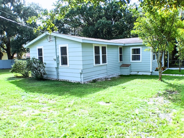 rear view of house with a yard