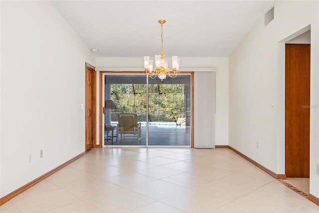 unfurnished room with a notable chandelier