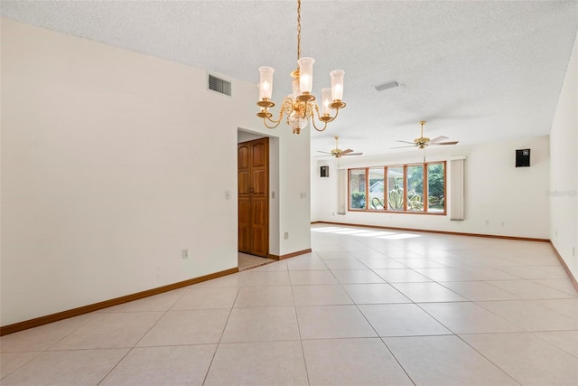 unfurnished room with ceiling fan with notable chandelier, light tile patterned floors, and a textured ceiling