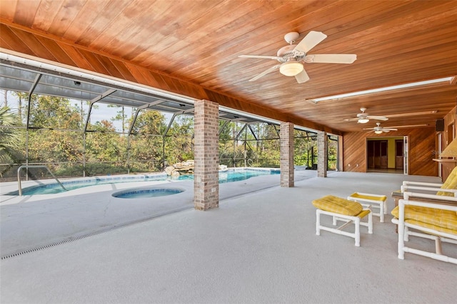 view of swimming pool with ceiling fan, a lanai, and a patio