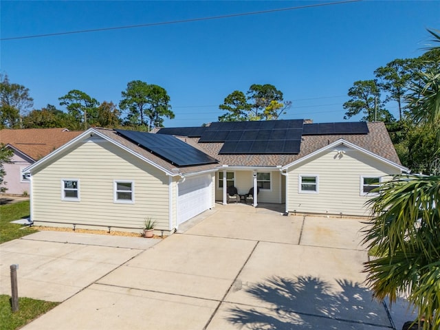 view of front of house featuring a garage and solar panels