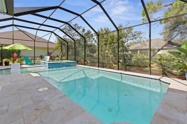 view of pool featuring a patio area, an in ground hot tub, and glass enclosure