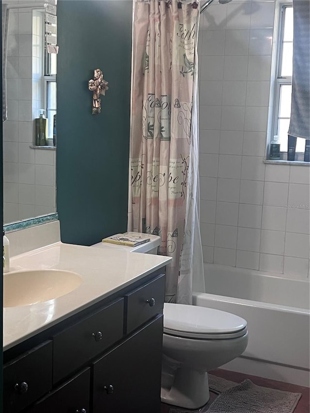 bathroom with toilet, shower / tub combo with curtain, and vanity