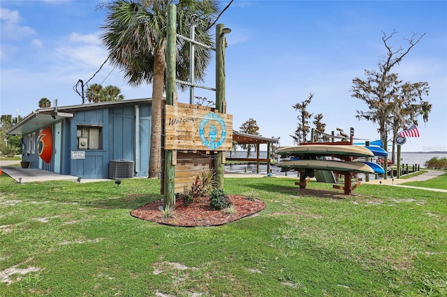 exterior space with a water view and a lawn