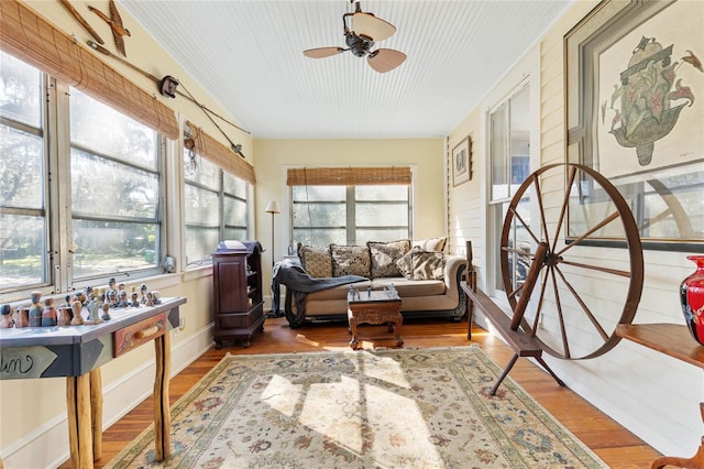 sunroom / solarium featuring plenty of natural light and ceiling fan