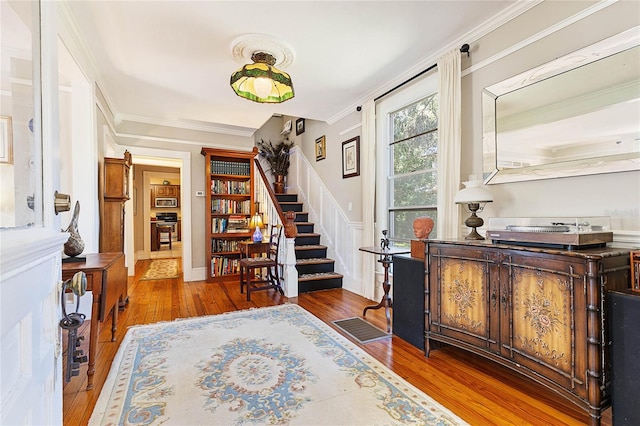 interior space featuring ornamental molding and wood-type flooring