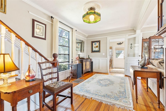 sitting room featuring crown molding and light wood-type flooring