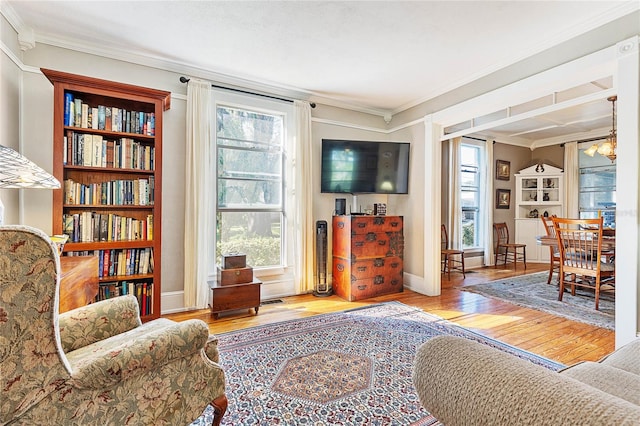 living room with light hardwood / wood-style flooring and ornamental molding