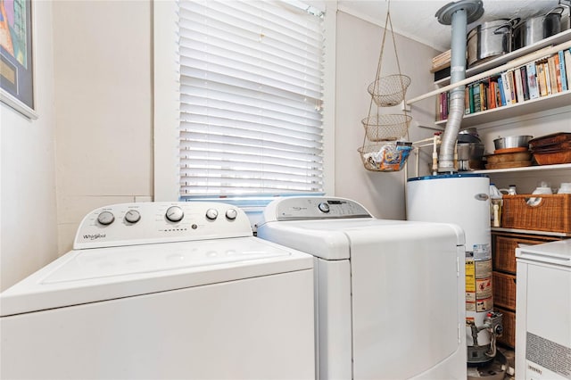 laundry area featuring water heater and washer and clothes dryer