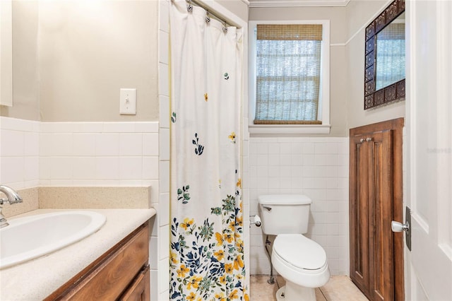 bathroom featuring tile walls, vanity, and toilet