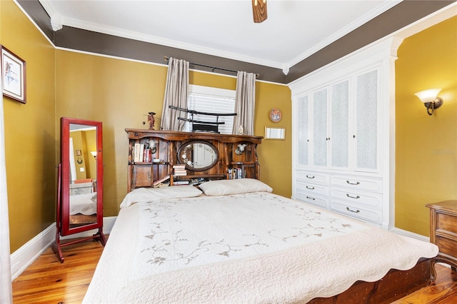 bedroom with ceiling fan, crown molding, and wood-type flooring