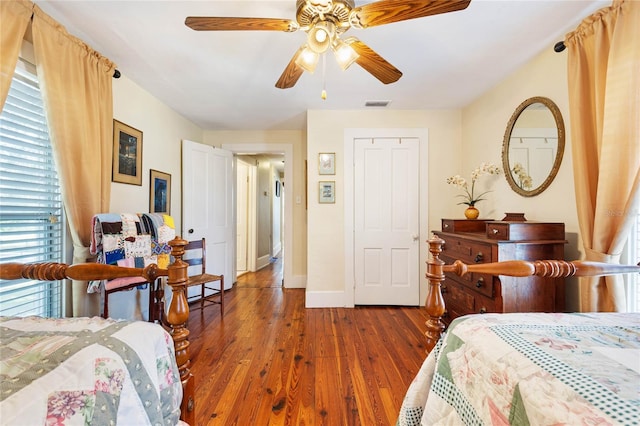 bedroom with dark wood-type flooring and ceiling fan