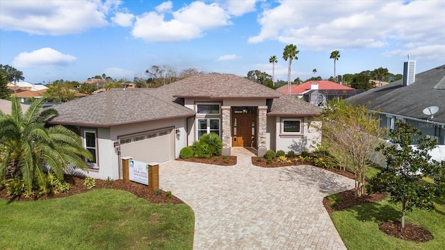 view of front facade featuring a garage and a front lawn