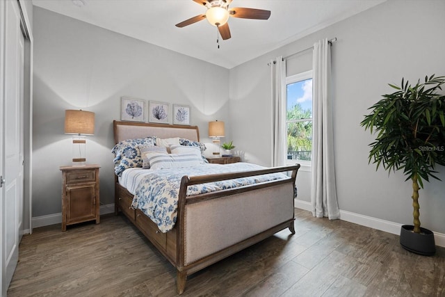 bedroom featuring a closet, dark hardwood / wood-style floors, and ceiling fan