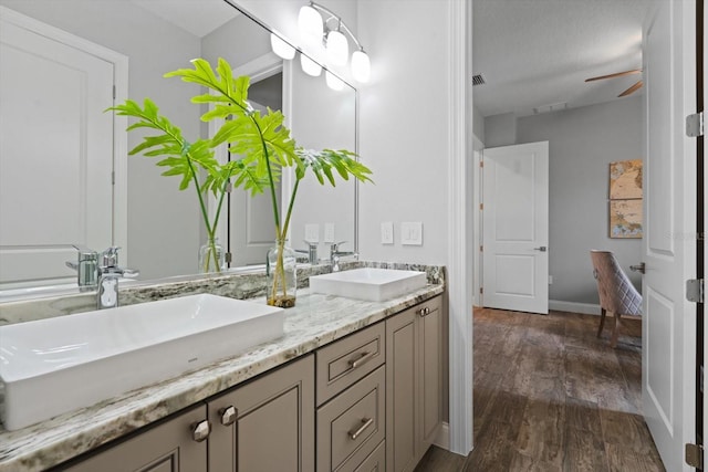 bathroom with vanity, hardwood / wood-style floors, a textured ceiling, and ceiling fan