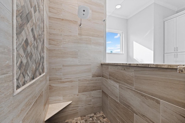 bathroom with crown molding and tiled shower