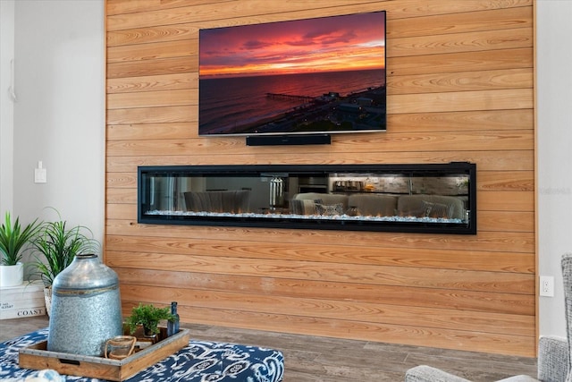 room details featuring wooden walls and hardwood / wood-style flooring