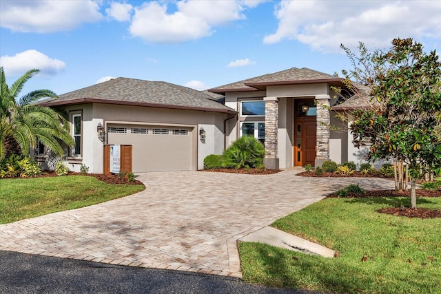 prairie-style house featuring a front yard and a garage