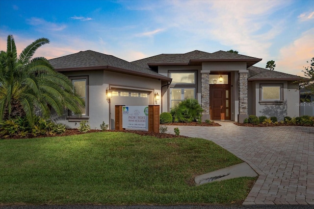 prairie-style home featuring a lawn