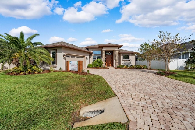 view of front of home featuring a front yard and a garage