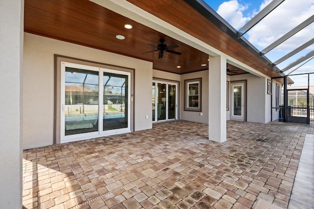 view of patio featuring a lanai and ceiling fan