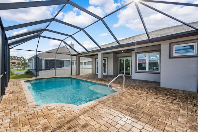 view of swimming pool with a patio area and a lanai