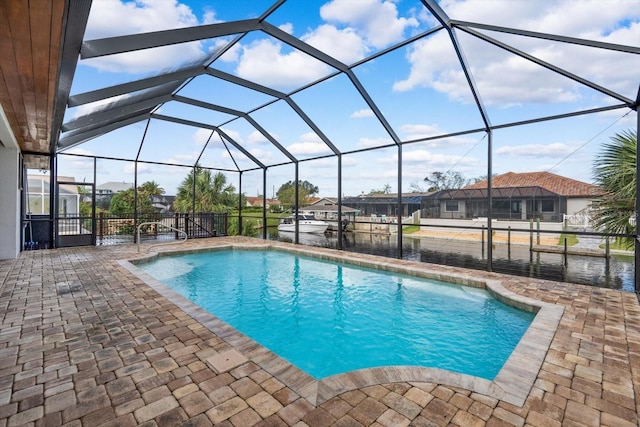 view of swimming pool with a patio and glass enclosure