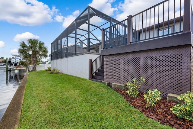 view of yard with a water view and glass enclosure