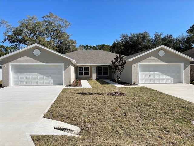 ranch-style house with a garage and a front lawn