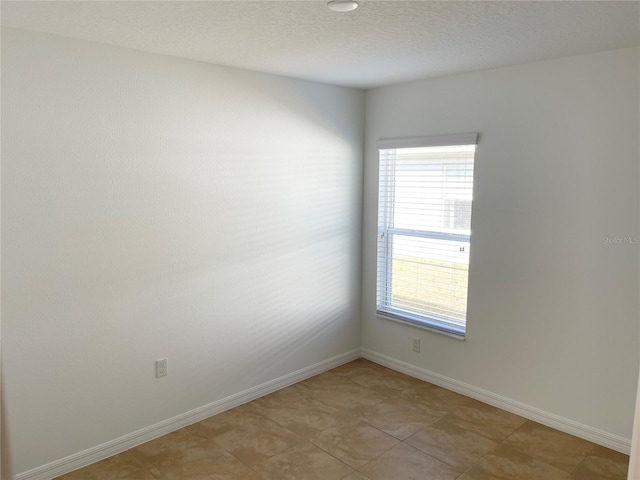 empty room with a textured ceiling