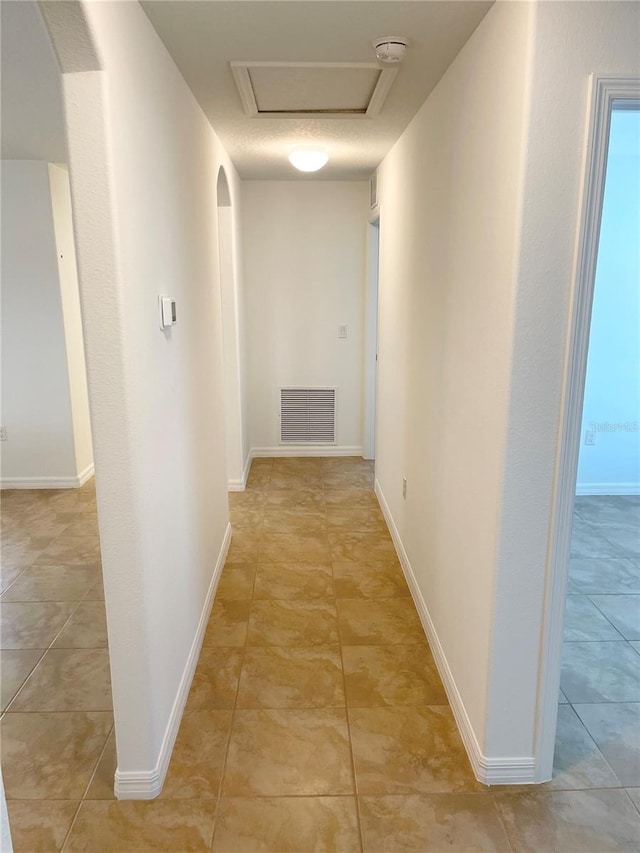 corridor with light tile patterned flooring