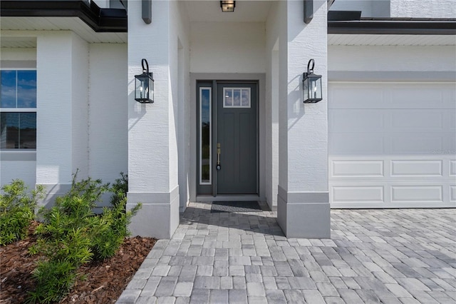 view of exterior entry with a garage