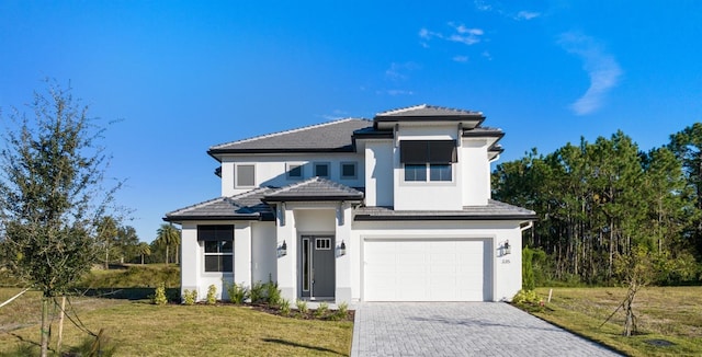 view of front of property with a front yard and a garage