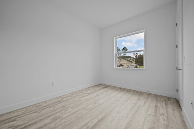 spare room featuring light wood-type flooring