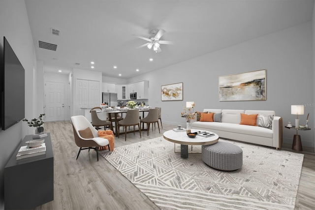 living room featuring light wood-type flooring and ceiling fan