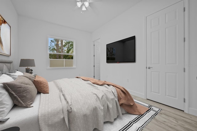 bedroom with light hardwood / wood-style floors and ceiling fan