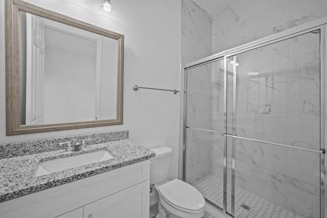 bathroom with walk in shower, vanity, and toilet