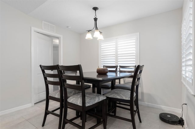 dining room featuring light tile patterned floors and a notable chandelier