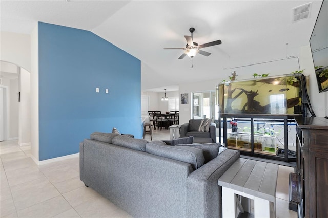 tiled living room featuring vaulted ceiling and ceiling fan