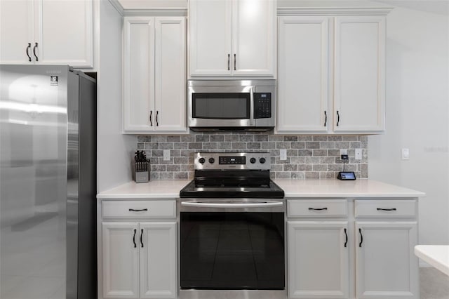 kitchen featuring tasteful backsplash, white cabinetry, and stainless steel appliances