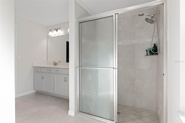 bathroom with tile patterned flooring, an enclosed shower, and vanity