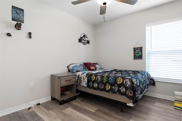 bedroom with multiple windows, hardwood / wood-style floors, and ceiling fan