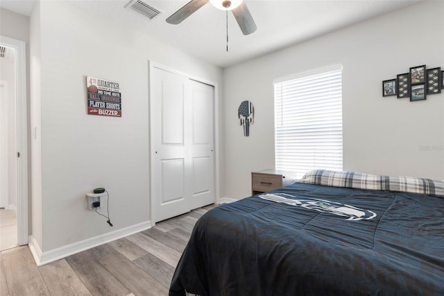 bedroom featuring a closet, light wood-type flooring, and ceiling fan